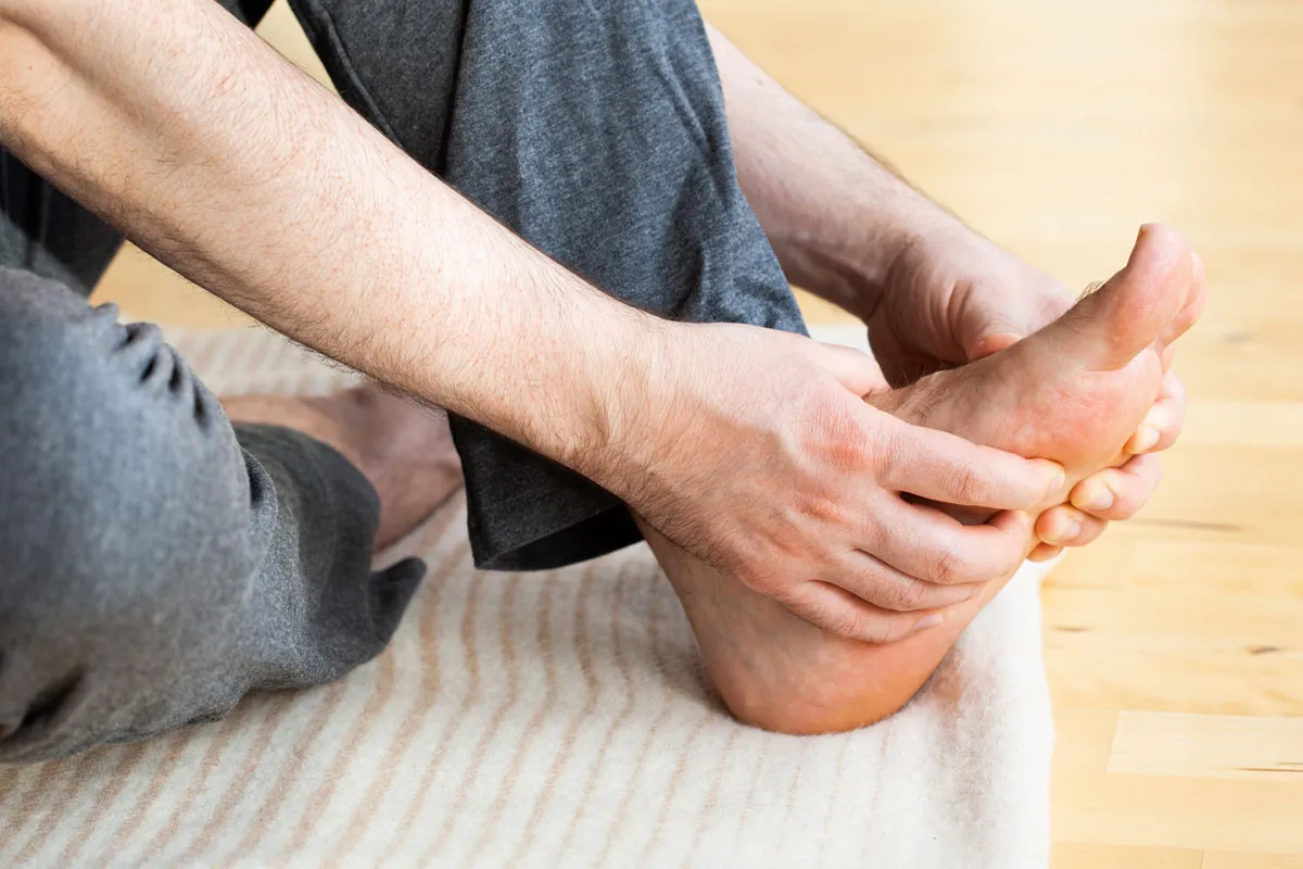 man doing flatfoot correction self massage at home 2023 11 27 05 06 32 utc